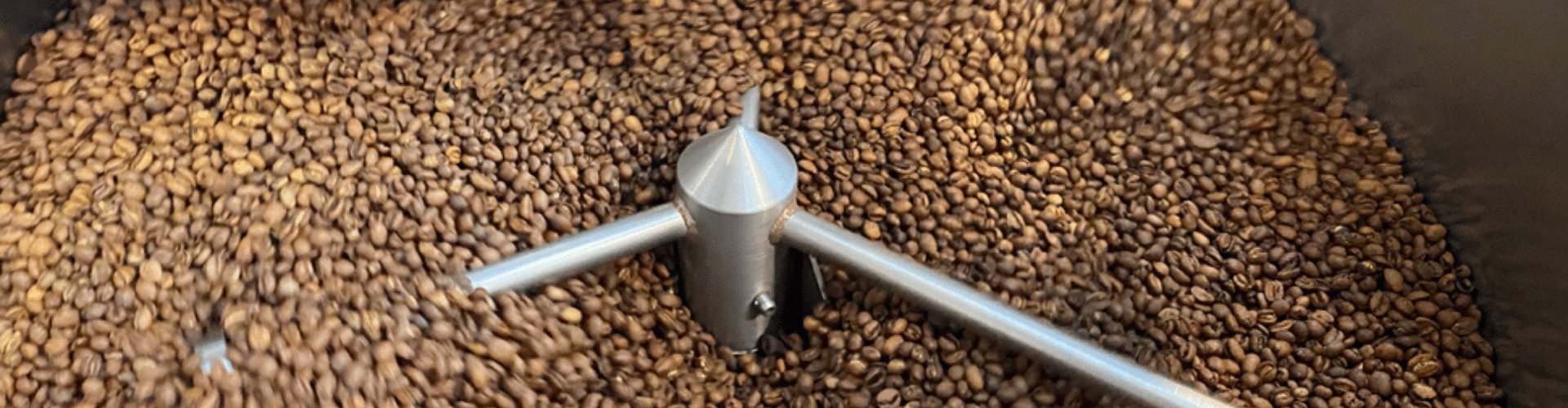 Unleashed Coffee: Sustainability in Coffee Roasting [image: coffee beans being roasted]